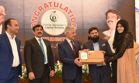Federal Minister for Defence, Water and Power Khawaja Muhammad Asif is distributed laptops among the brilliant students during a ceremony